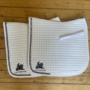 Loew Turnierschabracke Swarovski aus der Loew Kollektion in Weiß mit atmungsaktivem, schweißabweisendem Stoff und funkelnder Glitzerborte.