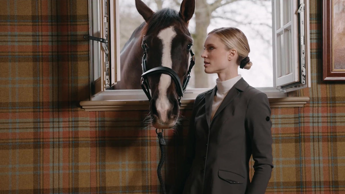 Pikeur brand image: rider and bay horse beside an open window.